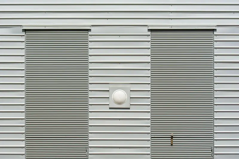 Metal wall siding with two roll-up doors
