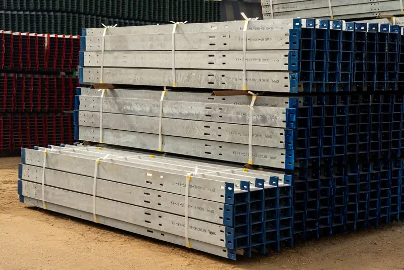 Stacks of steel framing members in a storage yard